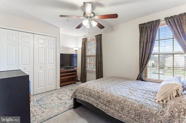 bedroom featuring carpet flooring, ceiling fan, and a closet