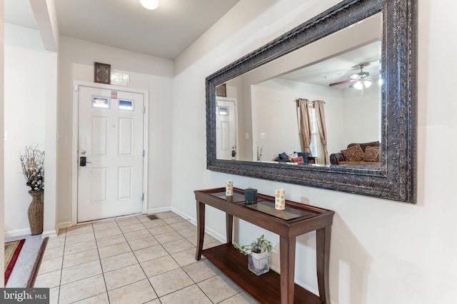 tiled entryway featuring ceiling fan