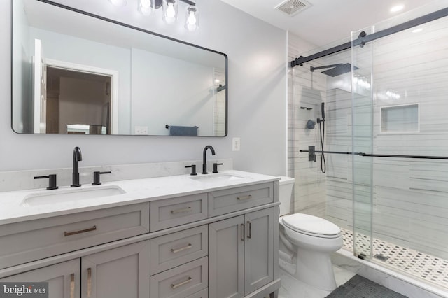 bathroom featuring vanity, toilet, and a shower with door