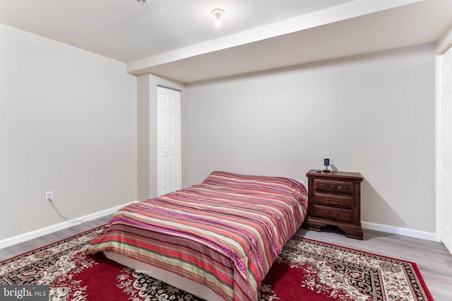 bedroom featuring light wood-type flooring and a closet