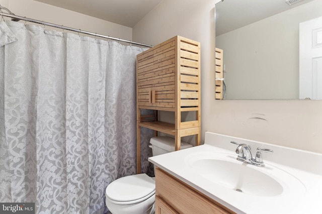 bathroom featuring vanity and toilet