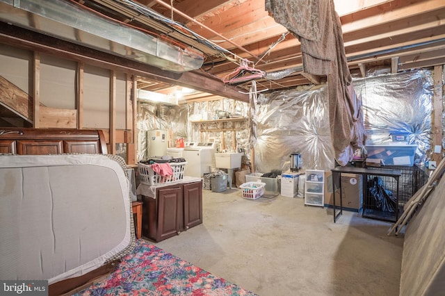 basement featuring separate washer and dryer and sink