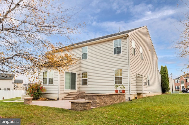 back of property featuring a yard and a patio