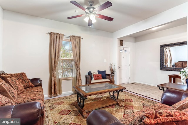 living room featuring ceiling fan and light tile patterned floors