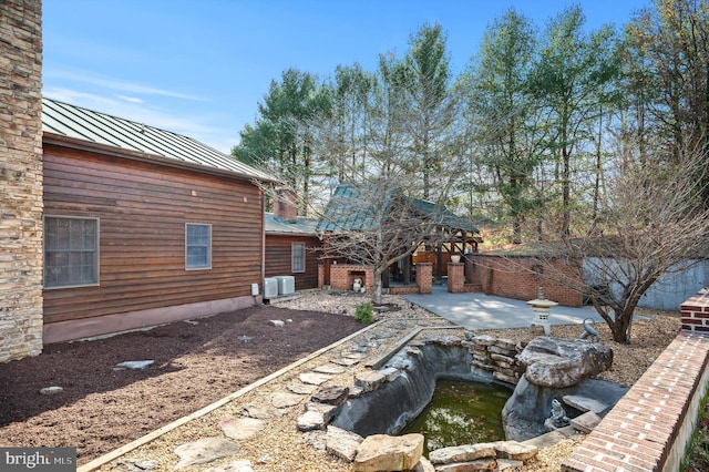 view of yard featuring a gazebo, a patio area, and central AC