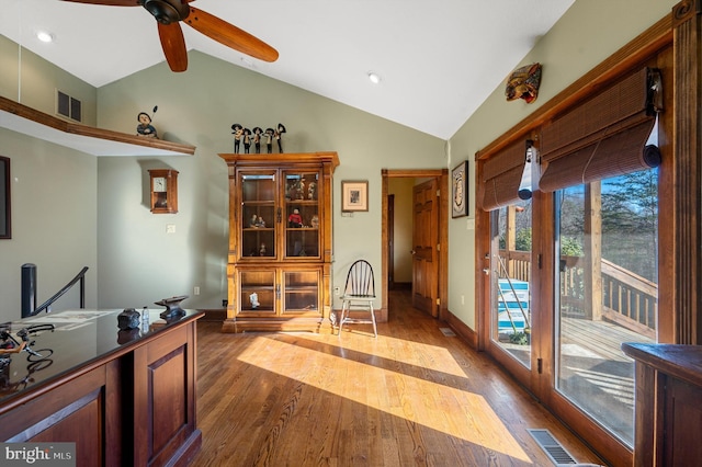 interior space featuring ceiling fan, dark wood-type flooring, and lofted ceiling