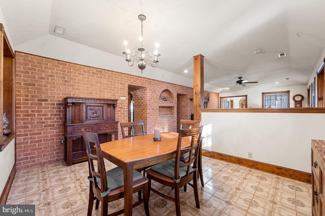 dining area with ceiling fan with notable chandelier and brick wall