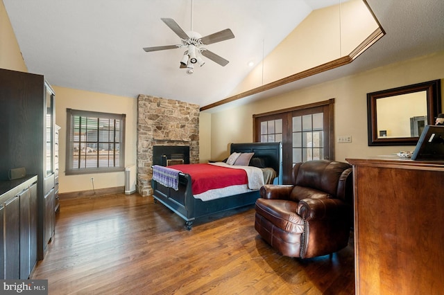 bedroom featuring hardwood / wood-style floors, vaulted ceiling, and ceiling fan