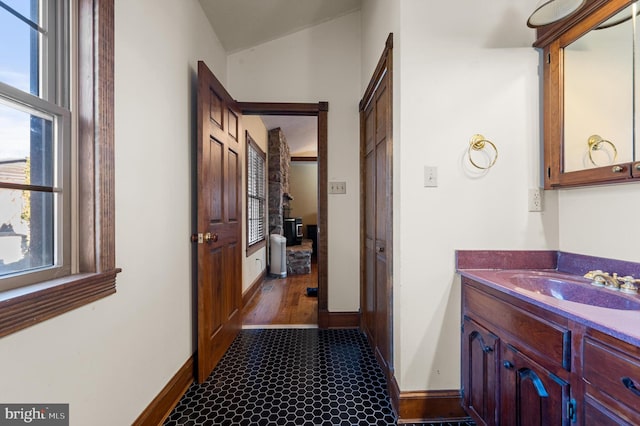 corridor featuring dark hardwood / wood-style floors, lofted ceiling, and sink