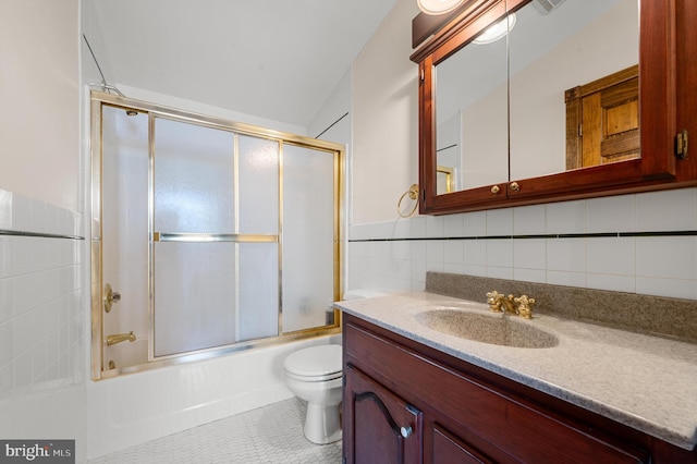 full bathroom with enclosed tub / shower combo, lofted ceiling, toilet, vanity, and tile walls