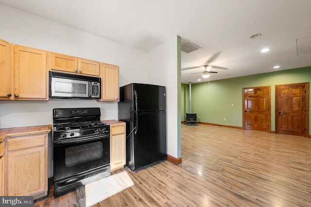 kitchen featuring ceiling fan, light brown cabinetry, black appliances, and light hardwood / wood-style floors