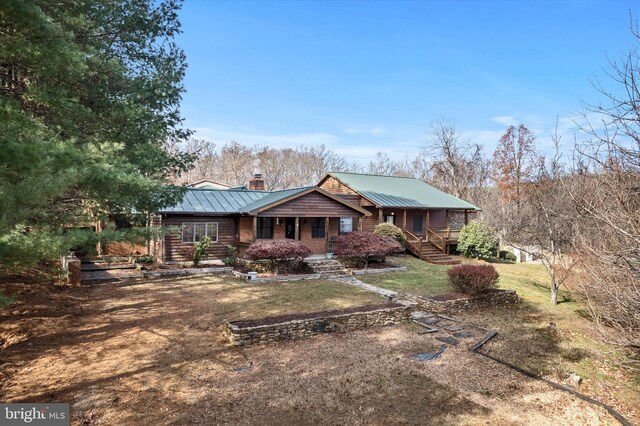 view of front of property with covered porch and a front yard