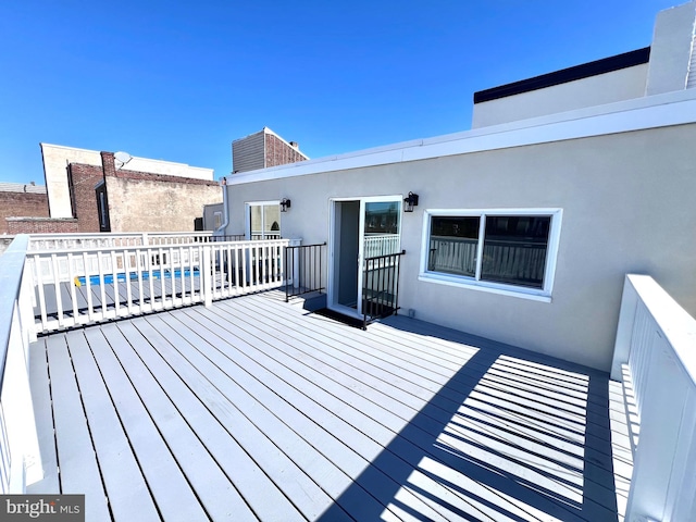 wooden terrace with a swimming pool