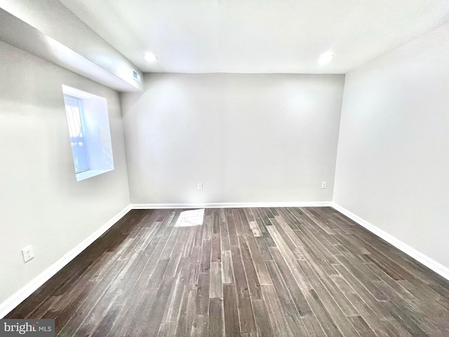 spare room with dark wood-type flooring