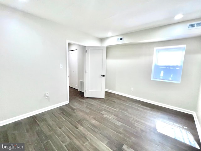 unfurnished bedroom with dark hardwood / wood-style floors