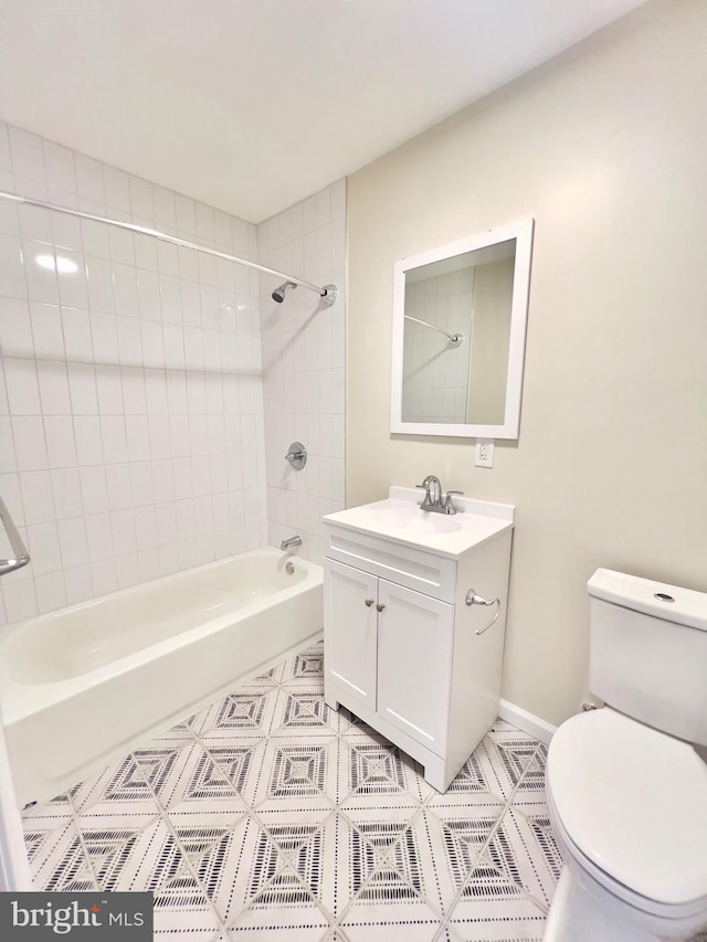 full bathroom with tile patterned floors, vanity, toilet, and tiled shower / bath combo