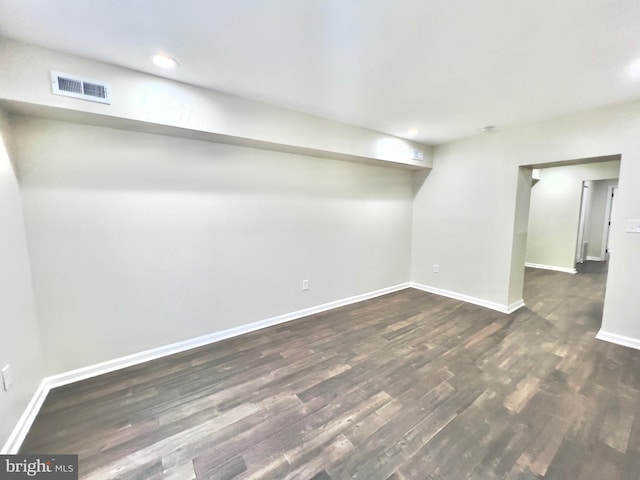 basement featuring dark hardwood / wood-style flooring