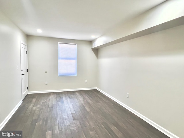 spare room with dark wood-type flooring