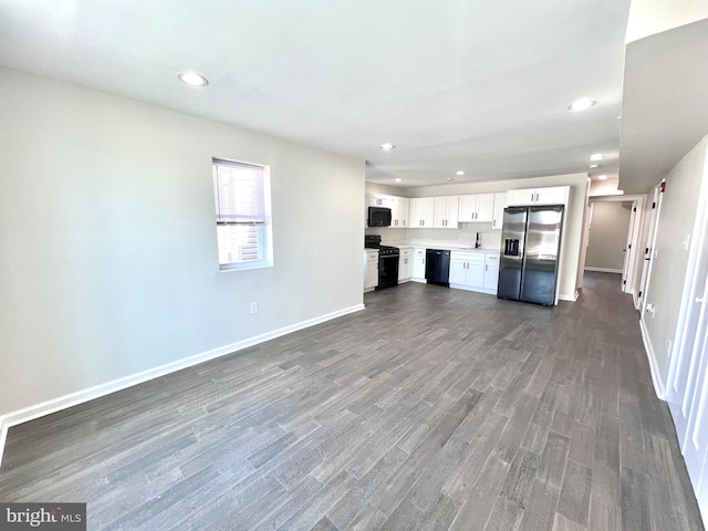 unfurnished living room featuring dark hardwood / wood-style flooring and sink