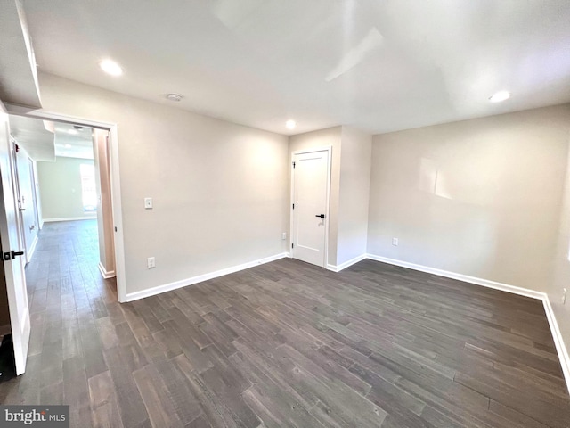 empty room with dark hardwood / wood-style floors