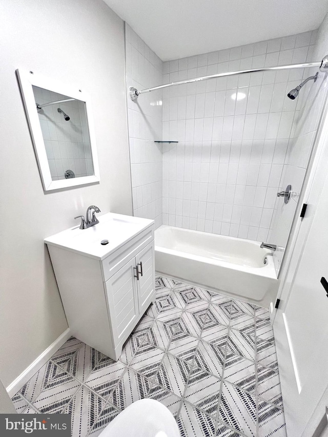 bathroom featuring vanity and tiled shower / bath