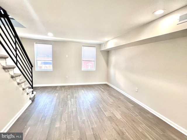 basement with hardwood / wood-style flooring