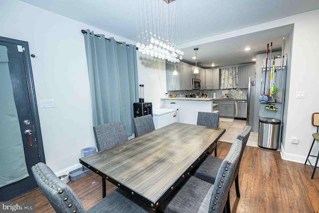 dining room featuring hardwood / wood-style floors and a notable chandelier