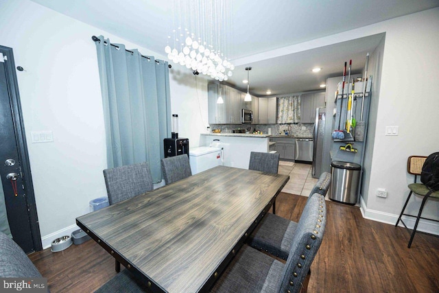 dining area featuring a notable chandelier and dark wood-type flooring