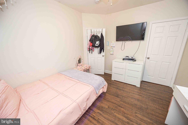 bedroom with dark wood-type flooring