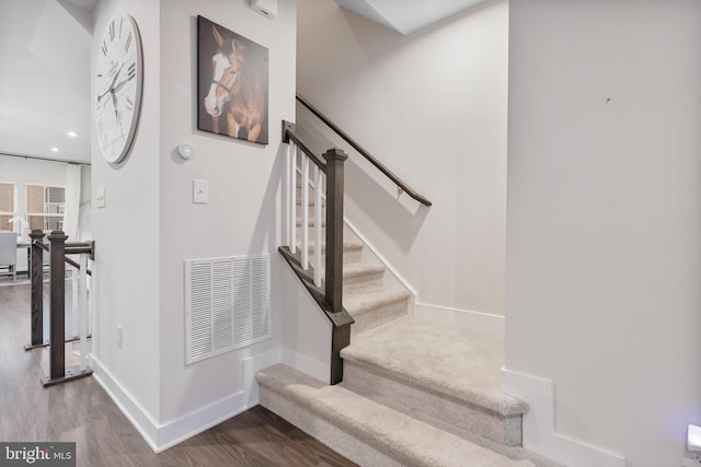 staircase featuring hardwood / wood-style flooring