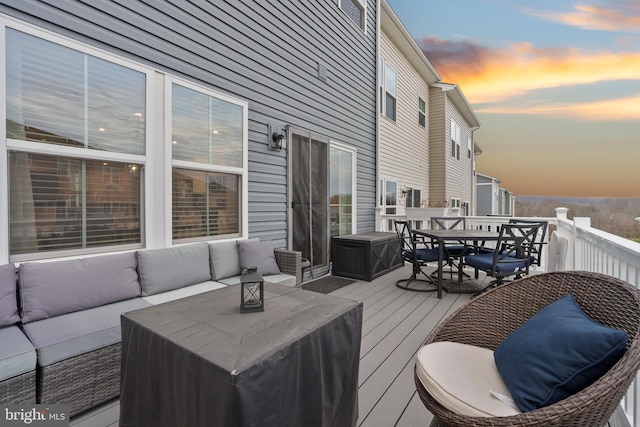 deck at dusk with outdoor lounge area