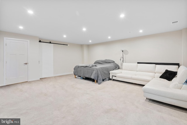 carpeted bedroom featuring a barn door