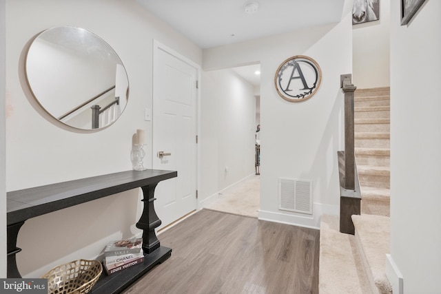 foyer entrance with hardwood / wood-style floors