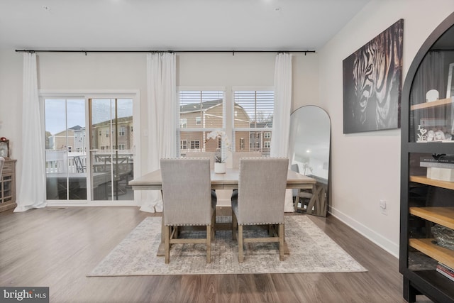 dining area featuring dark wood-type flooring