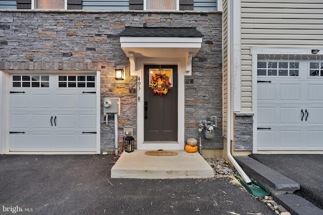 view of exterior entry with a garage