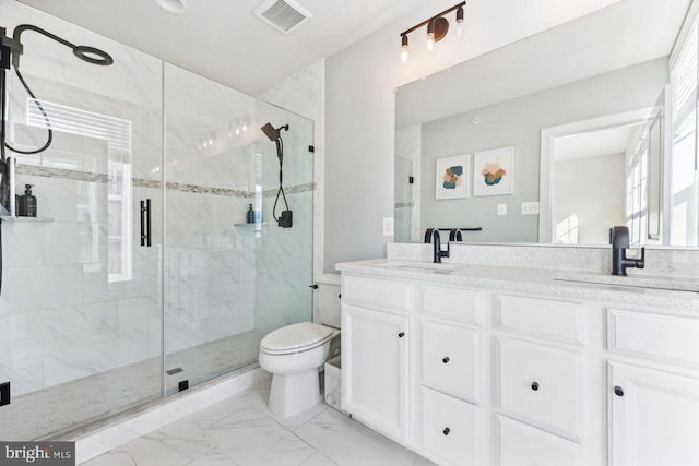 bathroom featuring vanity, toilet, and walk in shower