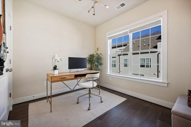 office space with dark hardwood / wood-style floors and an inviting chandelier