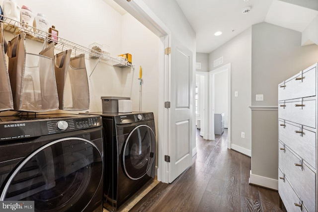 laundry area featuring washer and clothes dryer and dark wood-type flooring