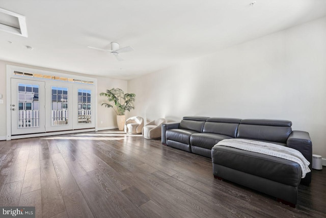 living room featuring ceiling fan and dark hardwood / wood-style flooring