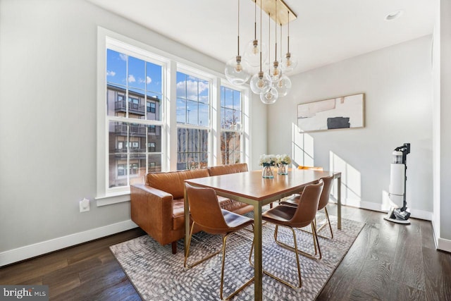 dining room featuring dark hardwood / wood-style floors and an inviting chandelier