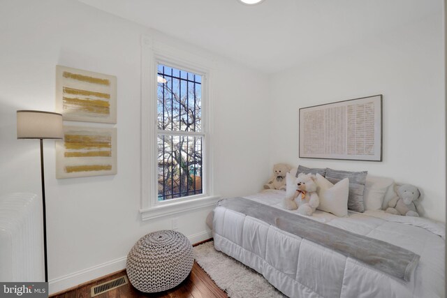 bedroom with wood-type flooring