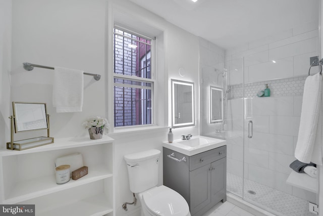 bathroom featuring toilet, vanity, and walk in shower