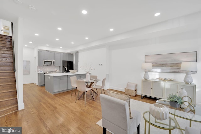 living room featuring light hardwood / wood-style flooring and sink