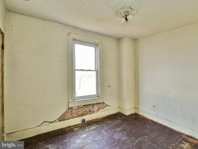 spare room with dark wood-type flooring