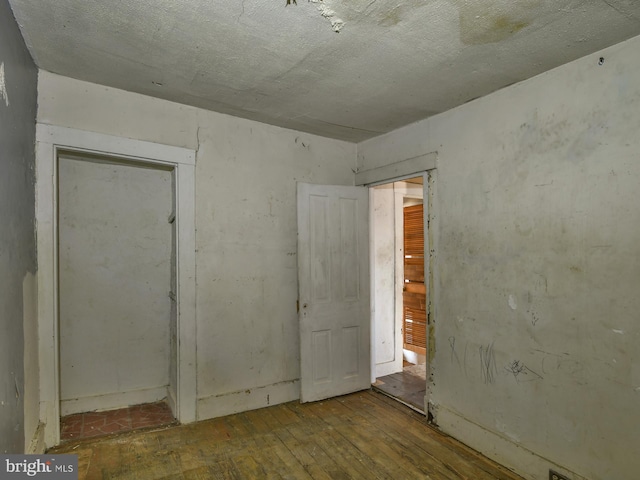 empty room with hardwood / wood-style floors