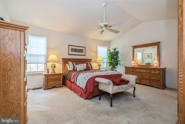 carpeted bedroom featuring ceiling fan and vaulted ceiling