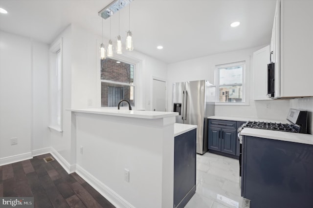 kitchen with white cabinetry, tasteful backsplash, stainless steel refrigerator with ice dispenser, blue cabinets, and pendant lighting