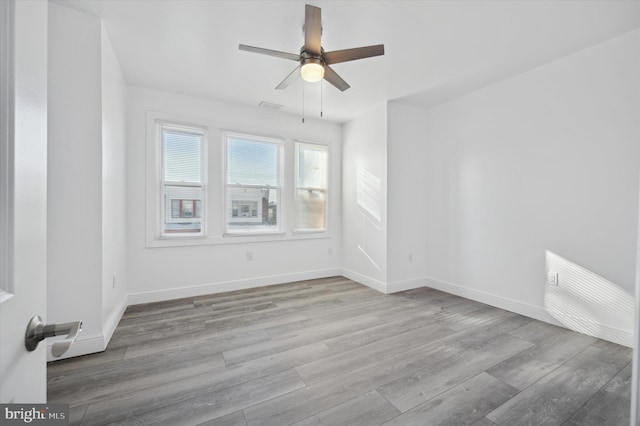 unfurnished room with ceiling fan and light hardwood / wood-style floors