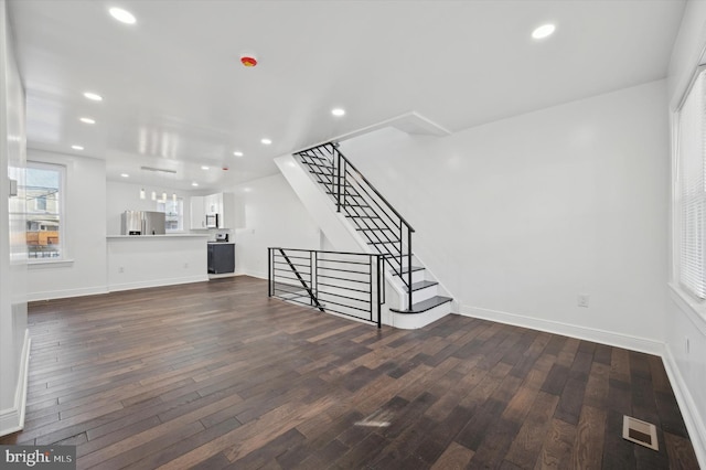 unfurnished living room with dark hardwood / wood-style floors