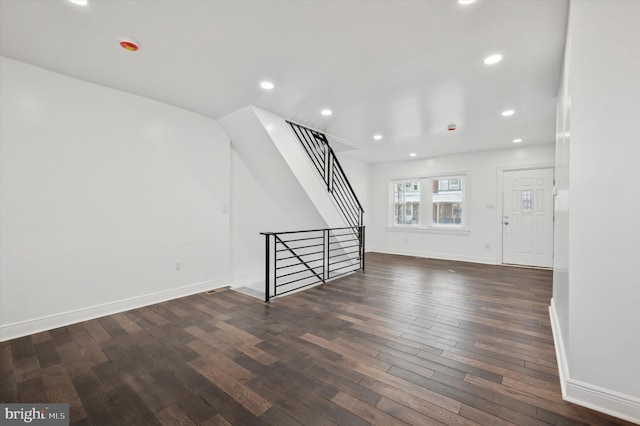 unfurnished living room with dark hardwood / wood-style flooring